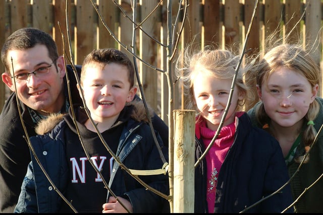 Dad Jim Staveley volunteers to help  pupils Joshua Hooton, Cara Graves and Olivia Kirkham plant trees at Sir Edmund Hillary School in Worksop in 2007.