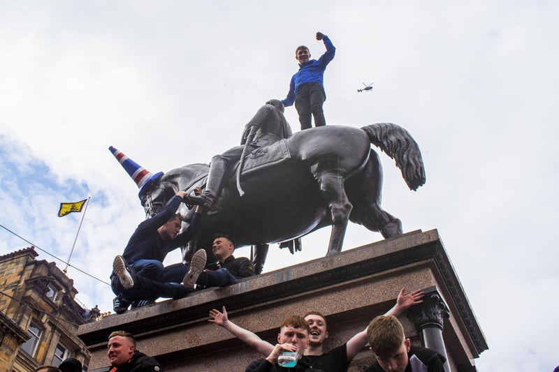 Rangers fans also clambered on statues in George Square