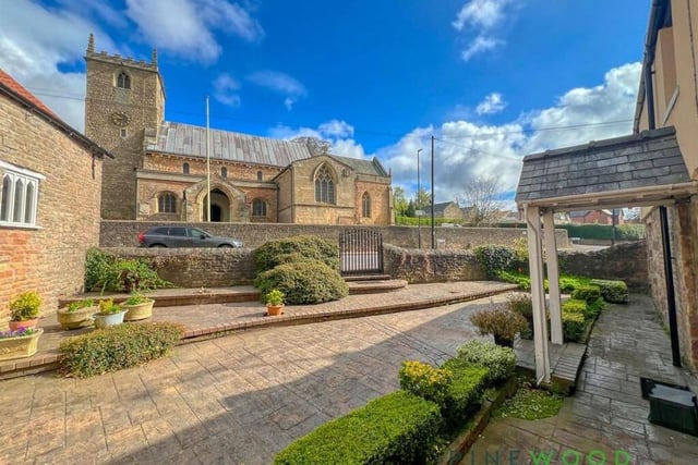 For the last photo in our gallery, we return to the front of the £725,000 property, where there is not only a courtyard garden, with space for plant pots and raised beds, but also a view of the ancient village church, St Lawrence's, across the road.