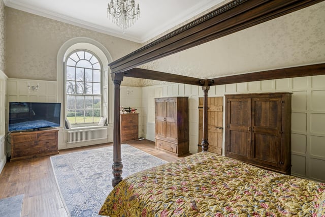 The property boasts no fewer than ten bedrooms -- and here is one of them. It is full of character, thanks largely to its beautiful, arched window.