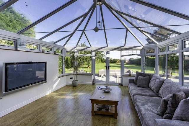 The stunning conservatory, which could be turned into a mini-cinema, is distinguished by its self-cleaning glass and underfloor heating. The wooden floor adds style, while French doors lead out to the back garden.