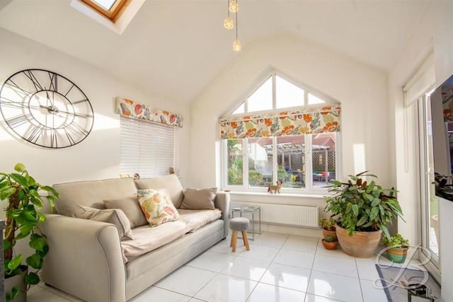 The first stop on our tour of the Shireoaks stunner is this bright garden room or lounge. It boasts a sparkling, tiled floor, windows to the side and back of the house and Velux roof windows too.