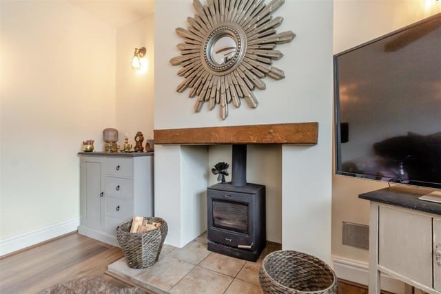 Here is a close-up of the log burner, with tiled hearth and oak mantle above, in the lounge.