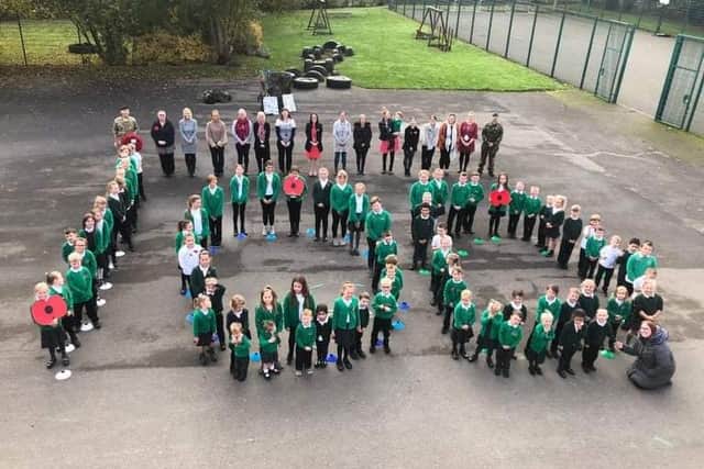 Around 90 pupils and staff paid their respects to veterans on the 100th Remembrance Day.