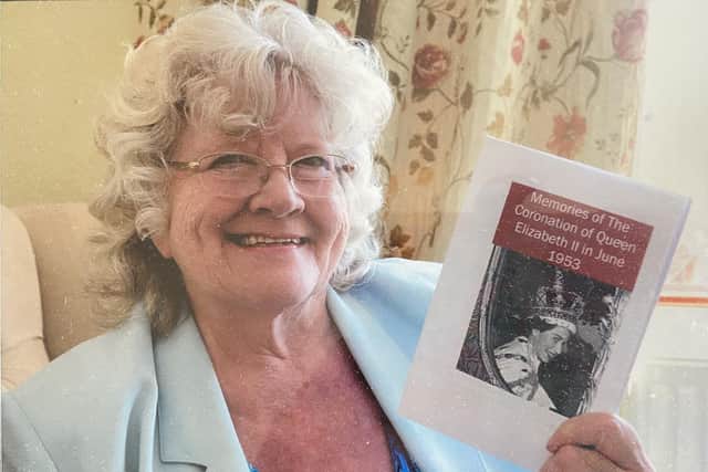Jackie Scott with her Queen's coronation booklet she created to raise cash for the Alzheimer's Society