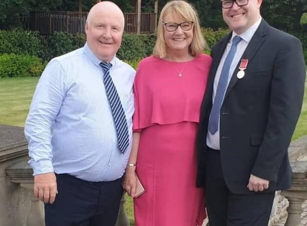 Damian Staples collecting his British Empire Medal, accompanied by his parents Kim and Tony Staples.