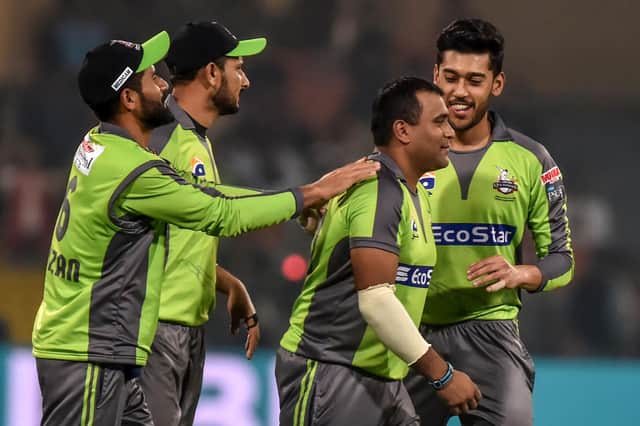 Samit Patel is congratulated by teammates after taking a wicket for Lahore Qalandars in the Pakistan Super League. (PHOTO BY: Arif Ali/Getty Images)