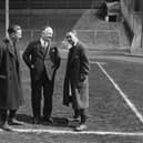 13th April 1932:  Arsenal Football Club Manager Herbert Chapman (centre), chats with a key member of his team , Alex James (right), on the pitch at Wembley before the FA Cup final.  (Photo by J. Gaiger/Topical Press Agency/Getty Images)