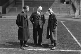 13th April 1932:  Arsenal Football Club Manager Herbert Chapman (centre), chats with a key member of his team , Alex James (right), on the pitch at Wembley before the FA Cup final.  (Photo by J. Gaiger/Topical Press Agency/Getty Images)