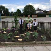 Andrew Rawson, General Manager at Notcutts Dukeries, with pupils from St John’s C of E Academy in their new remembrance garden.