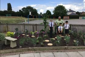 Andrew Rawson, General Manager at Notcutts Dukeries, with pupils from St John’s C of E Academy in their new remembrance garden.