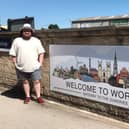 Kyle Emmerson with the new sign at Worksop train station.
