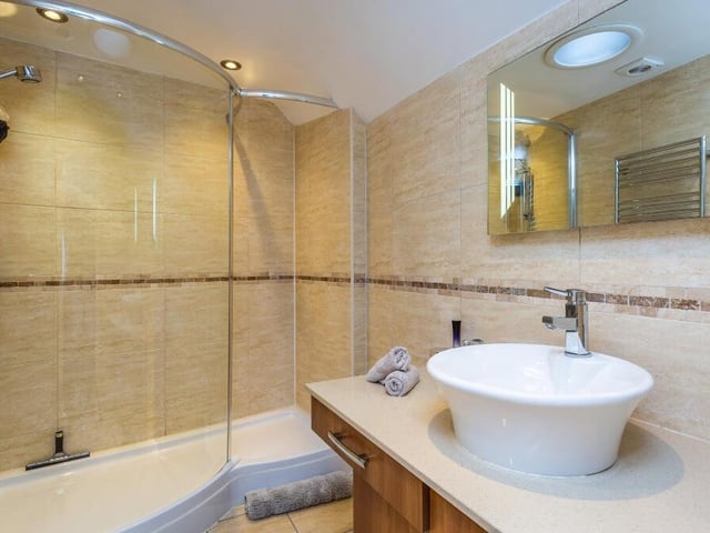The master bedroom also has access to this sleek en suite shower room.