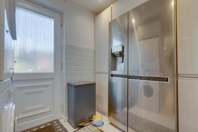 Next door to the kitchen is this convenient utility room, where there is space for an American-style fridge freezer and plumbing for an automatic washing machine. There are also fitted wall and base units.