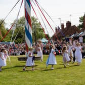 Big crowds watch children dancing around the maypole at Wellow's traditional event on Bank Holiday Monday.