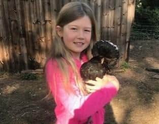 Lucy Broughton with one of the family chickens