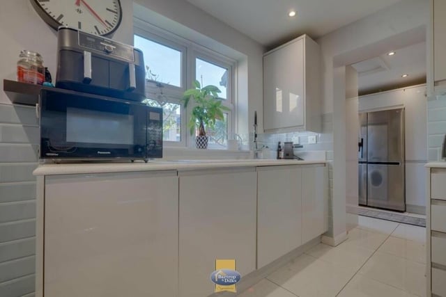 The kitchen also includes an enclosed gas-fired central heating boiler, as well as a storage cupboard. Just off it is a utility room.