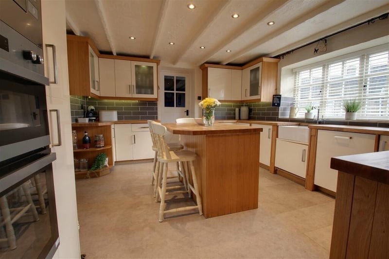 Integrated appliances in the kitchen and breakfast room include a double electric oven, a microwave, four--ring hob with extractor above, a dishwasher, fridge and freezer. It is a bright room thanks to a large window facing the front of the house