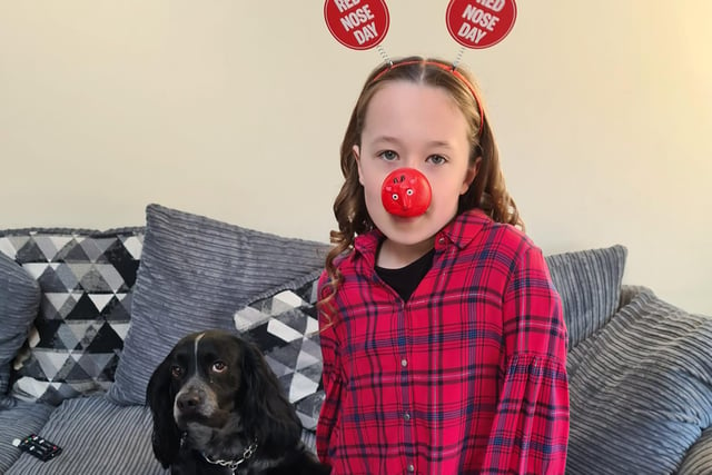 Besties Ruby, 10, and Ozzie the dog, six, showed their support for Comic Relief with a fun nose, headband, and good spirits.
