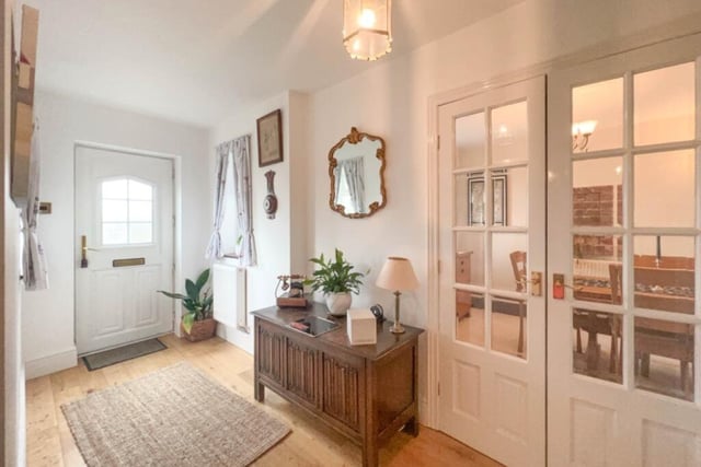 This entrance hallway welcomes you into the Worksop property. Either side of the front door are windows, while the floor is made of natural wood. Doors lead to the living room and dining room.