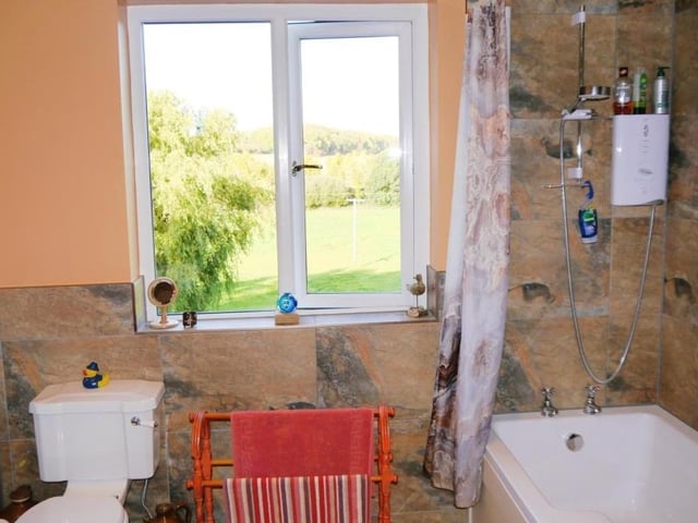 The bathroom offers more countryside views. It also features a heated towel-rail and even its own fireplace.