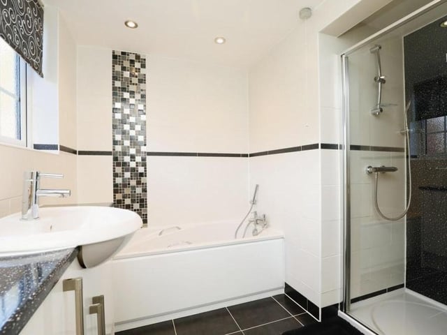 The family bathroom is stylish. It is fitted with a four-piece suite made up of a bath, separate, enclosed shower cubicle, wash hand basin, WC and tiled walls.