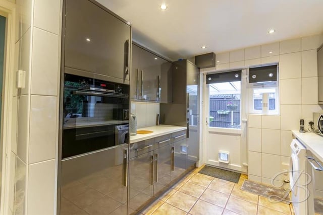 Deeper into the bungalow sits this kitchen, which comes complete with an attractive, modern range of grey gloss units and cabinets. Not forgetting complementary worktops, an inset sink and drainer, downlights, central heating radiator and windows to the side and rear of the property.