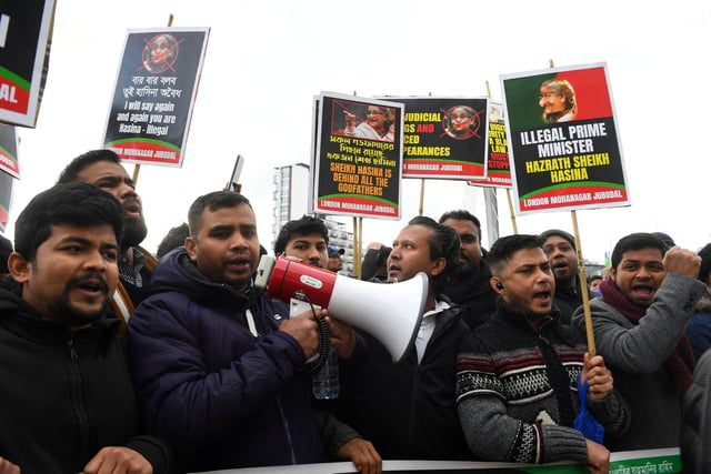 Protesters calling for the removal of Bangladesh's Prime Minister Sheikh Hasina hold placards as they demonstrate near the SEC.