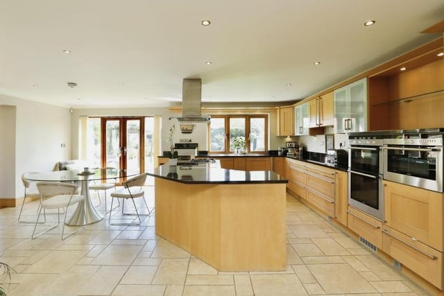 Let's start our tour of the Carlton in Lindrick gem in the spectacular, bespoke kitchen, which also combines as a breakfast and dining area with family living space. As you can see, it is a bright and modern room with a host of integrated appliances.