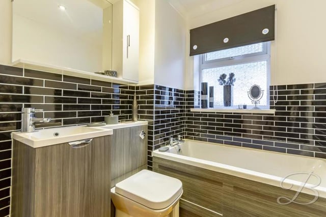 Our inspection of the £350,000 bungalow's interior is completed by a peek at the gorgeous family bathroom, complete with modern fixtures and fittings. It comprises a panelled bath, low-flush WC and wash basin with storage.