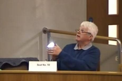 Objector Peter Clarke shone a torch during the meeting.