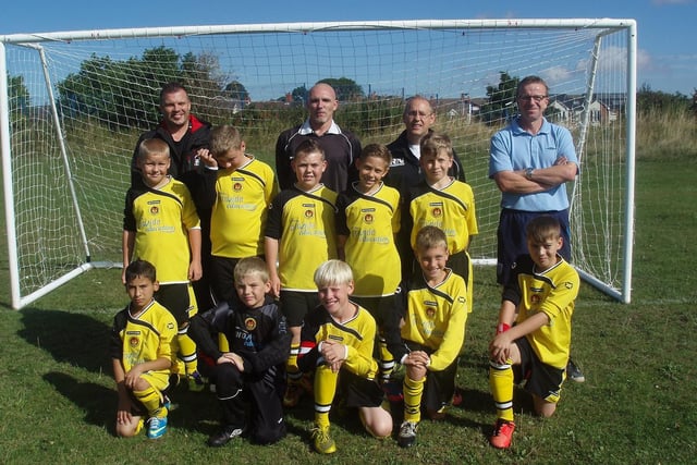 Dinnington Town Junior Football Club U11s back in 2014. Front from left: Erik Ziga, Rhys Lyons, Matthew Simmons, Ben Elliott and Louis Knight. Back: Kyle Richardson, Jack Booth, Blake Macefield, Lewis Nadin and Thomas Robinson. Far back: Adrian Knight with match officials. Players not pictured are Daniel Robinson, Callum Elliott and Ben Oliver.