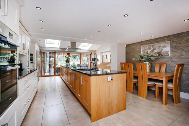 The kitchen has ample room for a large table and family sitting area. And at one end is an extension with two Fakro roof-lights and sizeable patio doors.