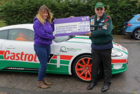 Stuart Dixon hands over a cheque to Mel Rose, community fundraiser for Bluebell Wood, in 2018