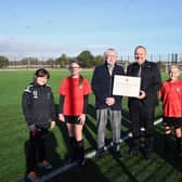 A new display celebrating legendary football manager Herbert Chapman has been created at Wales High School to celebrate the one-year anniversary of the opening of the 3G pitch at a Kiveton school. L-R Sophie H, Madeleine J, Ken Chapman, Pepe Di’Iasio, Lucas H and Billy G
