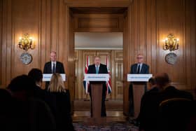 Chief Medical Officer Chris Whitty (L) and Chief Scientific Adviser Patrick Vallance (R) look on as Britain's Prime Minister Boris Johnson addresses a news conference to give a daily update on the government's response to the novel coronavirus COVID-19 outbreak, inside 10 Downing Street in London on March 19, 2020. (Photo by Leon Neal / POOL / AFP) (Photo by LEON NEAL/POOL/AFP via Getty Images)