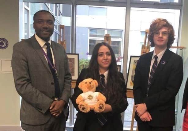 Godsway Dzoboku, principal of Outwood Academy City, with pupils as they mark the school achieving the IQM Flagship Award. The 'Dexter' bear is sent to each school which achieves the award.