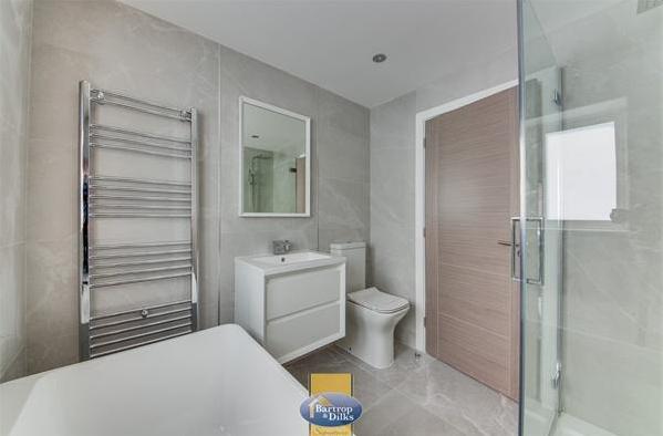 The bathroom has a free standing bath, double sized shower glass cubicle and mains shower unit, low flush w.c, wall mounted wash hand basin within a vanity unit, frosted rear window, two heated towel rails, tiling to walls and floor, extractor fan, spot lighting to the ceiling.