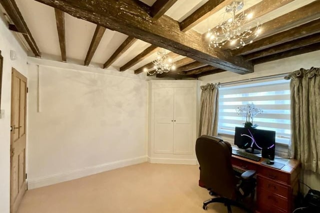 Traditional ceiling beams, which can be found throughout the Georgian farmhouse, are very much in evidence in this flexible room. It is currently being used as an office and craft room but could easily be turned into a playroom.
