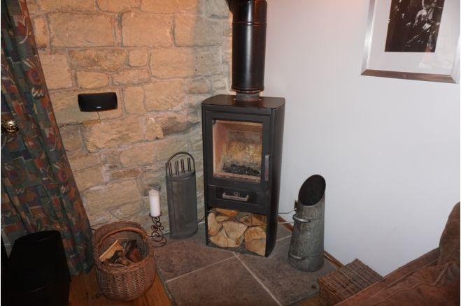 A feature of the room is this log burner, so you're sure to be cosy in winter.