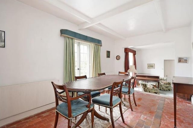 The lounge leads to this delightful dining room, which is distinguished by its stone floor.