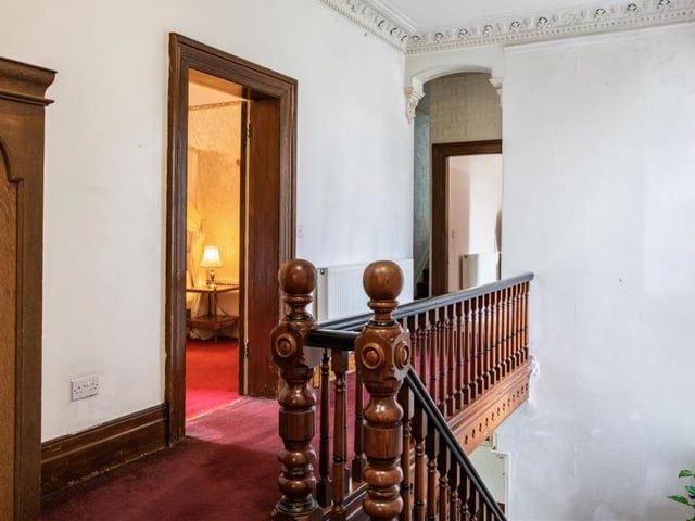 We're moving upstairs now - via the feature oak hand-carved staircase, which leads to a spacious galleried landing with high ceilings.