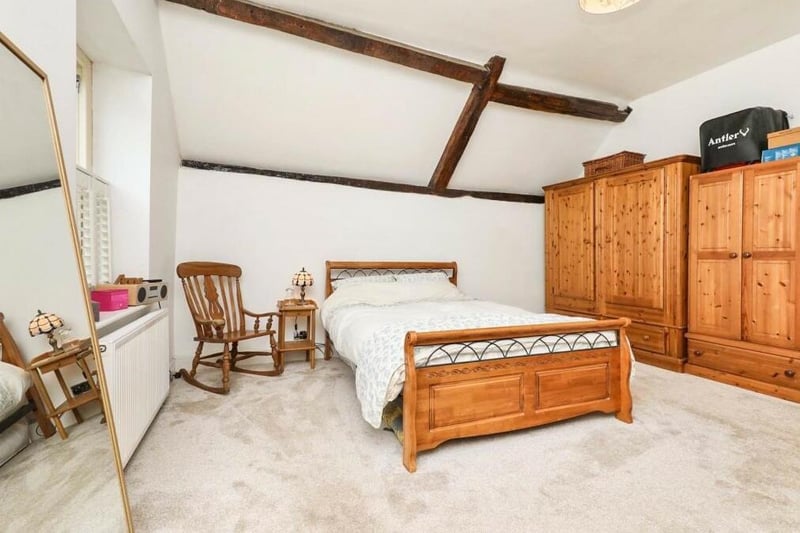 The master bedroom is a spectacular sight, especially with its cathedral-style beamed ceiling. There is lots of space for wardrobes and furniture, while two side-facing windows fill the room with natural light.