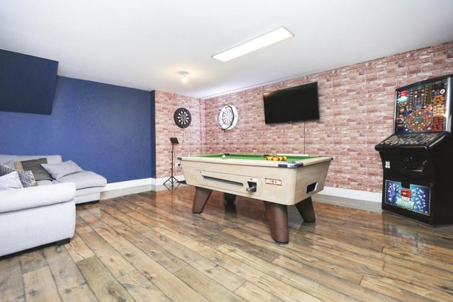This games room at the Shireoaks property is actually part of the integral double garage, which is fully insulated and has spotlights, a TV point, electric heater and wall-mounted boiler. Up-and-over doors provide access to a storage area.