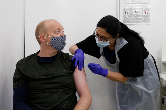 Martin Gillibrand, 45, receives an AstraZeneca vaccination. (Photo by Hollie Adams/Getty Images)