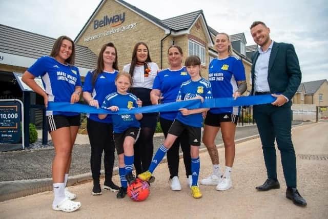 Claire Brown, Director of Football for SJR Worksop FC’s Women’s and Girls’ Teams, cuts the ribbon to officially open the Spinner show home at Bellway’s Gateford Quarter development in Worksop, watched by (back from left) SJR Worksop women’s captain Abbie Lister, women’s team treasurer Kelly Hale, Bellway Sales Advisor Lana Corbett, goalkeeper Olivia Walker, Bellway East Midlands Sales Manager Adam Champion, and (front from left) junior players Peyton Smith, nine, and Layla Stanley, 11.