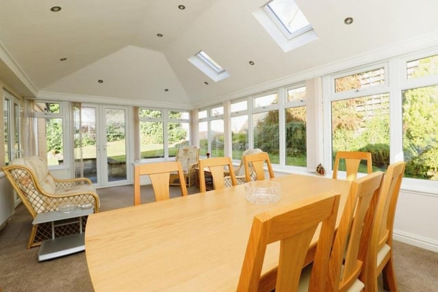 The conservatory or garden room at the back of the property is a great size, with room for a dining table and chairs. Windows offer views of the side and back of the house, while French doors open out on to the garden. Two Velux windows allow even more light into the room.
