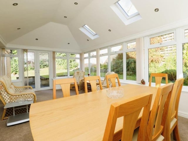 The conservatory or garden room at the back of the property is a great size, with room for a dining table and chairs. Windows offer views of the side and back of the house, while French doors open out on to the garden. Two Velux windows allow even more light into the room.