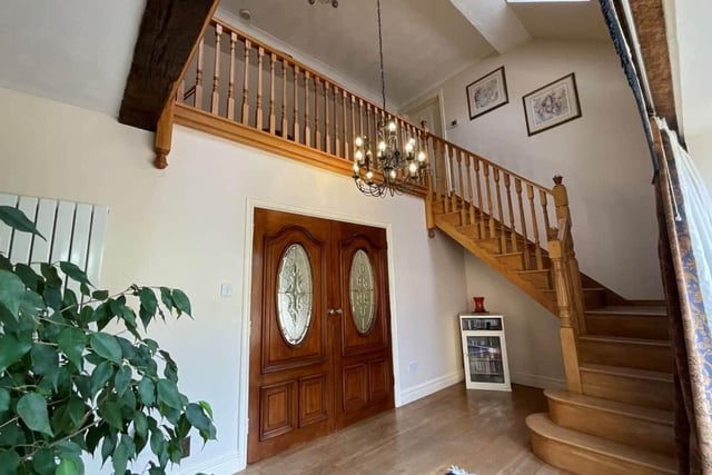A gorgeous wooden staircase leading up to a galleried landing.