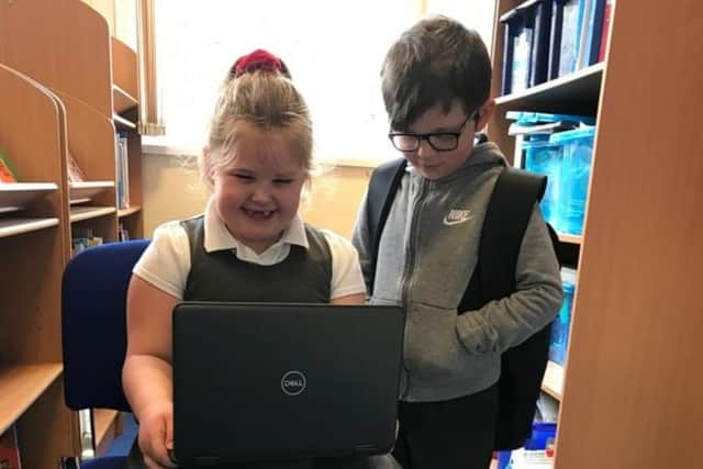 Pupils ay Langold Dyscarr Community School with one of the new laptops.